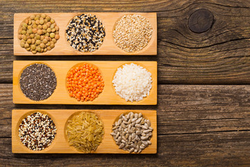 whole grains, seeds, cereals collection, old wooden table background