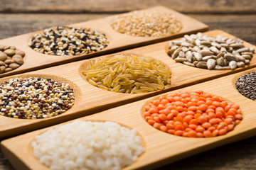 Fototapeta premium whole grains, seeds, cereals collection, old wooden table background