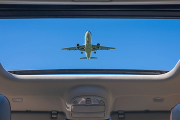 airplane from open hatch of the car during summer vacation. Travel and freedom concept