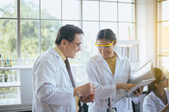 Group Of Asian Scientist Working And Analyzing Data Research In The Laboratary