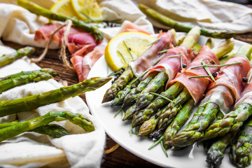Green roasted asparagus with meat. Appetizer on plate.