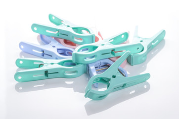 plastic clothespins on white background
