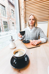 Woman drinking coffee in a cafe