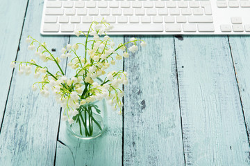keypad and white flower bunch on blue table