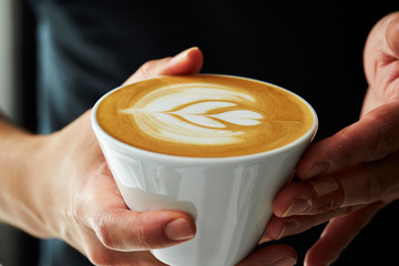 A man holding cafe latte 