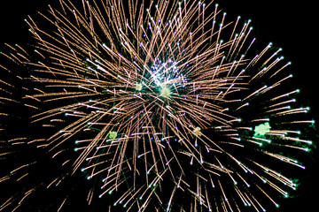 Salute, fireworks in the night sky. Pyrotechnic show on a holiday. Explosion of many firecrackers.