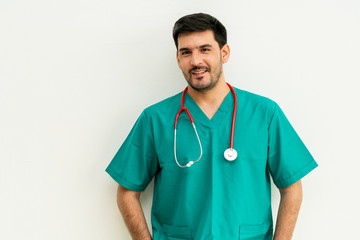 Portrait of young male medical staff in green uniform with stethoscope on white background. Medical...