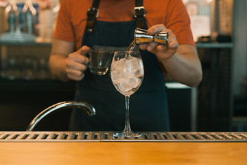Barman making a cocktail at the bar