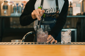 Barman making a cocktail at the bar