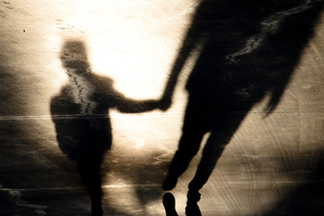 Shadow silhouettes of father and son walking hand in hand - 267031218