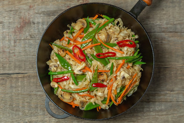 Chow Mein egg noodles with vegetables and mushrooms. The view from the top. Copy-space