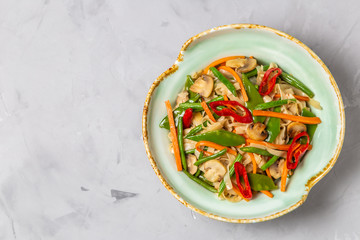 Chow Mein egg noodles with vegetables and mushrooms. The view from the top. Copy-space