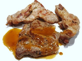 Top view of grilled pork steak with sauce isolated on white background, Ready to eat, Selective focus 