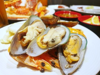 Top view of steamed mussels cooked steak on sweet shrimp on white plate in restaurant, Ready to eat or cooking