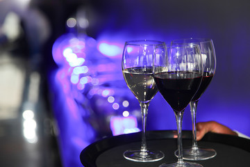 two glasses of wine on black background