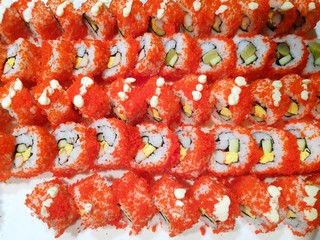 Japanese food style, Top view of california roll maki sushi with crab meat, mayonnaise, cucumber, avocado, caviar and sweet omelette as a background, Ready to eat or serve