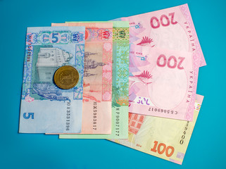 Ukrainian hryvnia, various bills. Coins in 1 hryvnia. Cash. The background of the sea-green. Free...