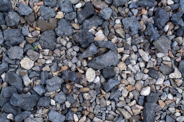 Background with pieces of coal lying on gravel