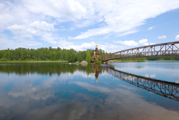 Fototapeta premium Panorama of the Vuoksa River overlooking the Church of St. Andrew the First Called on a sunny summer day. Leningrad region, Russia