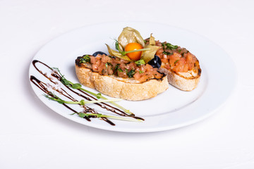 Delicious Italian antipasti bruschetta on white background. Close-up.