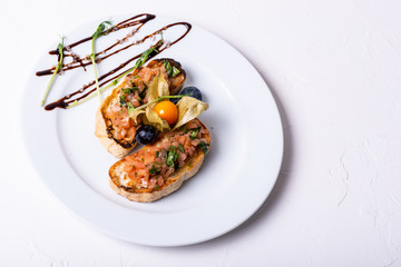 Delicious Italian antipasti bruschetta on white background. Macro. Copy space. Top view.