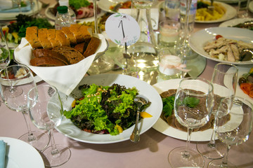 Served for banquet restaurant table with dishes, snack, cutlery, wine and water glasses, european food, selective focus