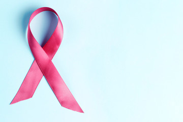 pink ribbon on light blue background, breast cancer concept