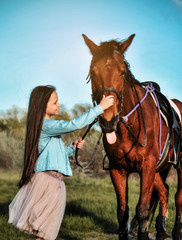Fototapeta premium Beautiful girl with horse on the grass. Friendship concept.