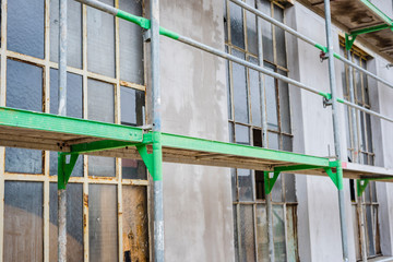 Construction site with steel scaffolding to carry out repairs on the wall