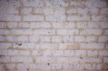 Abstract solid background depicting an old white wall, painted, worn and scratched by time.