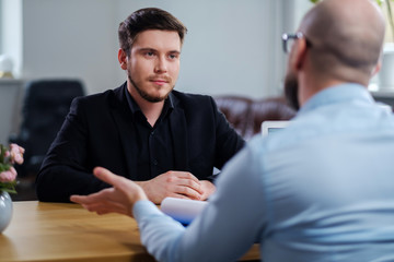 Confident young man attending job interview