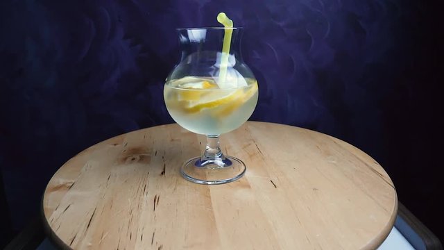 Refreshing soda tonic with lemon and ice in a glass. Cold lemonade mojito drink. Fresh summer beverage concept