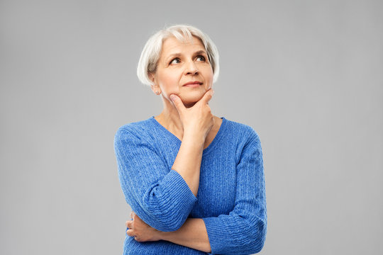 Old People And Decision Making Concept - Portrait Of Senior Woman In Blue Sweater Thinking Over Grey Background