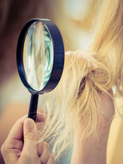 Woman looking at her through magnifer