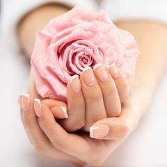 Woman gets manicure procedure in a spa salon. Beautiful female hands.