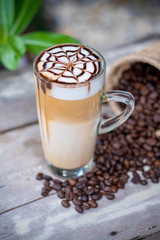 Hot latte macchiato coffee with chocolate syrup art