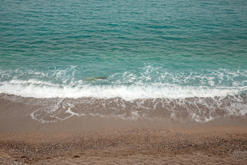 Fantastic turquoise crystal clear water, sand and pebbles of the Agia Kyriaki beach in the Kiparissi Lakonia village, Peloponnese, Zorakas Bay, Greece, evening - May 2019.