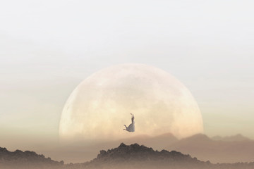 freedom concept of a woman jumping in front of a giant moon