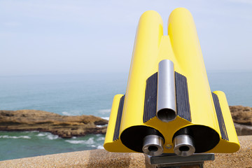 In the foreground a coin operated telescope in the background a view Rock of the Virgin Mary in...