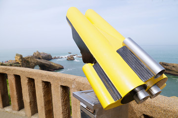 In the foreground a coin operated telescope in the background a view Rock of the Virgin Mary in...