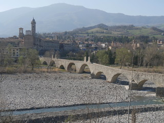 Devil's bridge in Bobbio. Stone arch bridge over the Trebbia river that was a Roman road in...