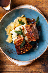 Pork belly with crispy crackling, mash potatoes and apple sauce