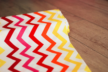 Colorful zigzag cotton fabric on wooden background