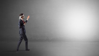 Businessman fighting with boxing gloves in an empty space
