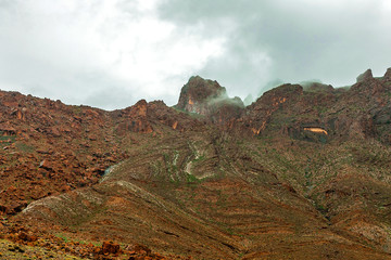 View of the Atlas Mountains in Morocco. Fog over high mountain peak