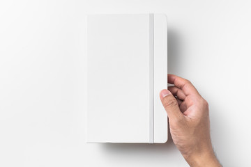 white notebook hold by man hand