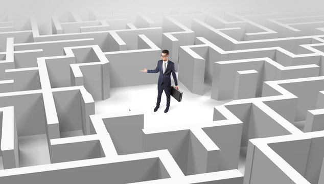 Young businessman standing in a middle of a 3D maze

