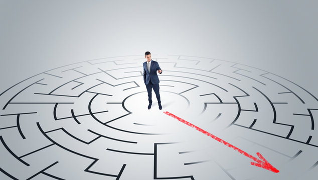 Businessman going through the maze with red arrow
