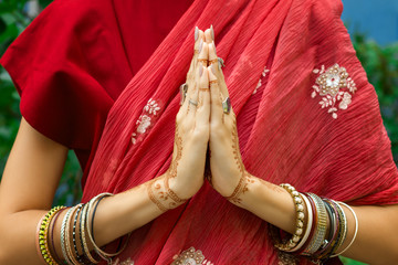 Beautiful woman wear traditional Muslim Arabic Indian wedding pink red sari dress hands with henna...
