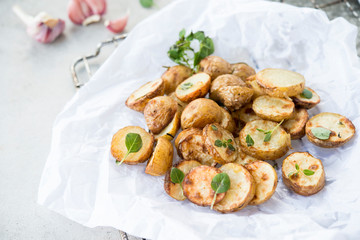 Baked potatoes in rustic style with green pesto sauce